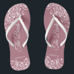 White Lace on Dusty Rose Elegant Bride's Wedding Jandals<br><div class="desc">Dance the night away with these beautiful wedding flip flops. Designed for the bride, they feature a simple yet elegant design with fancy script lettering on a dusty rose or mauve pink background and white lace curls and swirls. Beautiful way to stay fancy and appropriate while giving your feet a...</div>