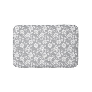White lace pattern on grey background bath mat