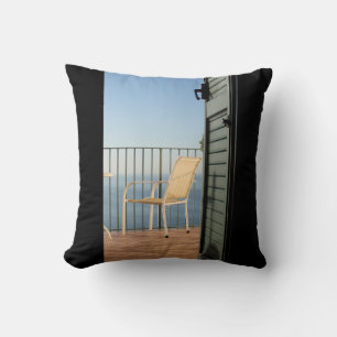 White metal armchair beside fence in the morning cushion