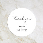 White Modern Script Wedding Thank You Classic Round Sticker<br><div class="desc">Introducing our White Modern Script Wedding Thank You Classic Round Sticker design, where modern minimalism meets the artistry of calligraphy. This curated aesthetic brings an air of sophistication to your special day- with a twist of boho, casual charm. The combination of simple typography with a stylish script font adds a...</div>