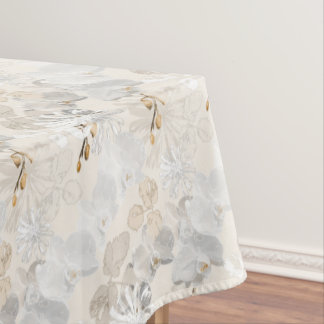 White orchids on a light cream tablecloth