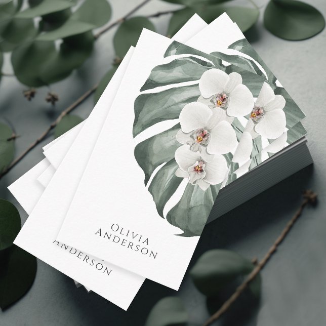 White Orchids on Monstera Tropical Botanical Business Card (A stunning business card with a tropical elegance featuring white orchids on a monstera leaf.)