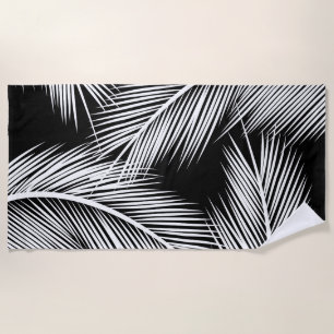White palm leaves on black colour background beach towel
