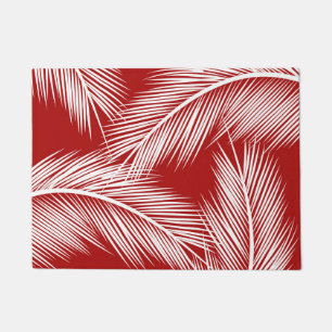 White palm leaves on red colour background doormat