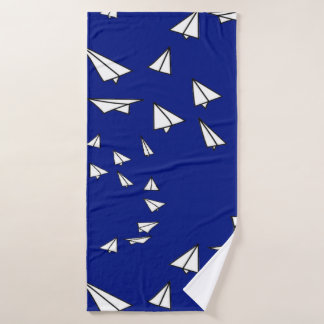 White paper planes on blue bath towel