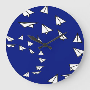 White paper planes on blue large clock