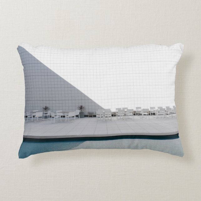 WHITE PATIO TABLE WITH CHAIRS DURING DAYTIME DECORATIVE CUSHION (Front)