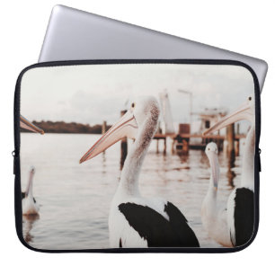 WHITE PELICAN ON BODY OF WATER DURING DAYTIME LAPTOP SLEEVE