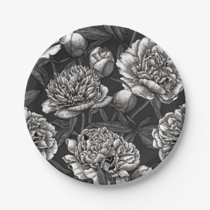 White peony flowers on dark grey paper plate