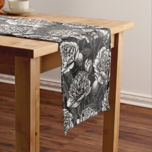 White peony flowers on dark grey short table runner