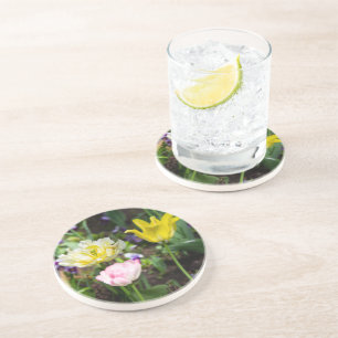 White, pink and yellow tulips in the garden coaster