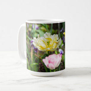 White, pink and yellow tulips in the garden coffee mug