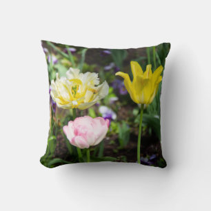 White, pink and yellow tulips in the garden cushion