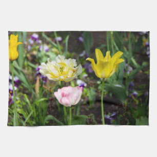 White, pink and yellow tulips in the garden tea towel