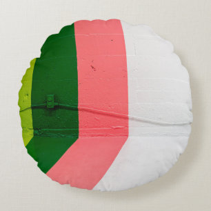 White, pink, green, and yellow painted wall round cushion