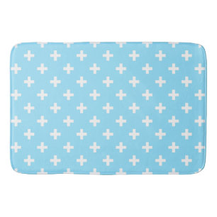 White polka crosses on baby blue bath mat