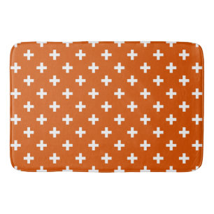 White polka crosses on burnt orange bath mat