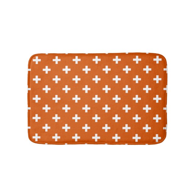 White polka crosses on burnt orange bath mat (Front)