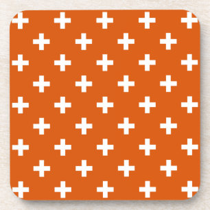 White polka crosses on burnt orange coaster