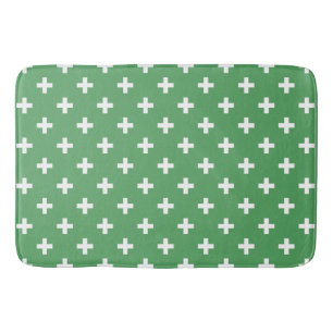 White polka crosses on green bath mat