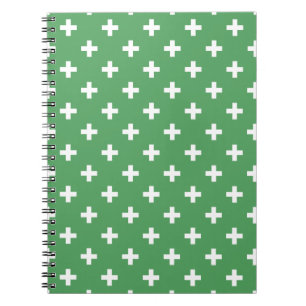 White polka crosses on green notebook
