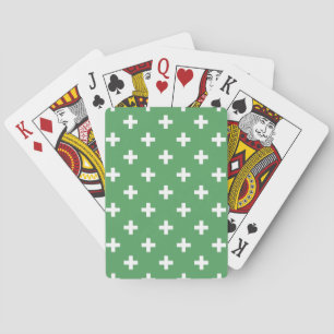 White polka crosses on green playing cards