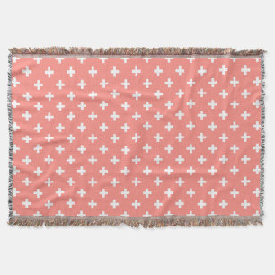 White polka crosses on peach throw blanket