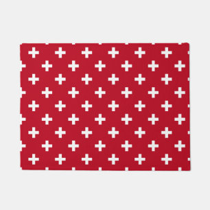 White polka crosses on red doormat