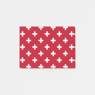 White polka crosses on red post-it notes
