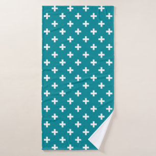 White polka crosses on teal bath towel