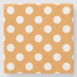 White polka dots on amber stone coaster