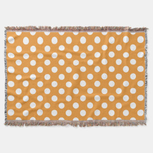 White polka dots on amber throw blanket