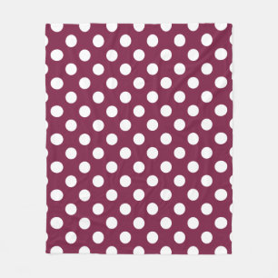 White polka dots on burgundy fleece blanket