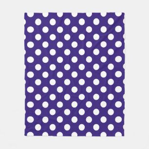 White polka dots on dark blue fleece blanket