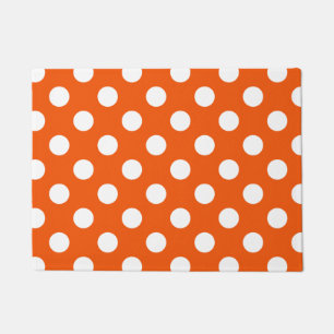 White polka dots on orange doormat