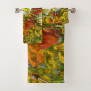 White poppies growing around the colourful flowers bath towel set