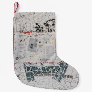 White printer paper on white and grey concrete wal small christmas stocking