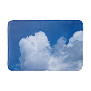 White puffy clouds in blue sky bath mat