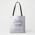 White Reflections Wedding Maid of Honour Tote Bag<br><div class="desc">This beautiful tote bag is perfect for thanking your Maid of Honour. It features black text over a background of reflecting white peony flowers and hearts. The text is fully customisable and reads: Maid of Honour, with a place for her name, the couple's names and wedding date. Perfect for filling...</div>