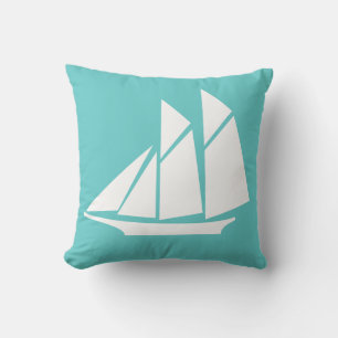 white sailboat  on teal blue pillow