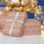 White Script Ho Ho Ho Brown Christmas Wrapping Paper<br><div class="desc">Introducing our Modern Christmas Wrapping Paper, a chic and understated way to add a touch of festive elegance to your holiday gifts. This wrapping paper features a soothing light brown background adorned with a stylish pattern of cursive "ho ho ho" in white. The elegant script dances across the paper, exuding...</div>