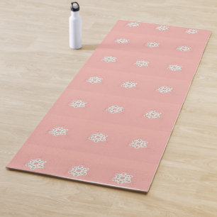 White snowflake on pink yoga mat