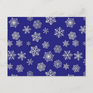 White snowflakes against deep cobalt blue postcard