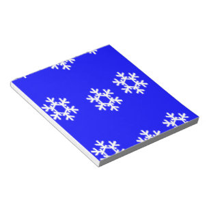 White snowflakes on blue notepad