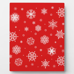 White snowflakes on red background plaque