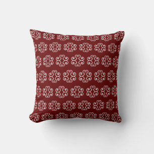 White spiral vector pattern on deep red cushion