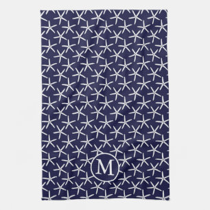 White starfish on a navy blue background tea towel