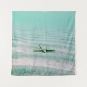 White starfish on sand underwater in the morning tapestry