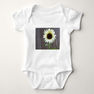 White sunflower against a weathered fence baby bodysuit