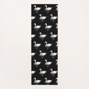 White swan on black yoga mat